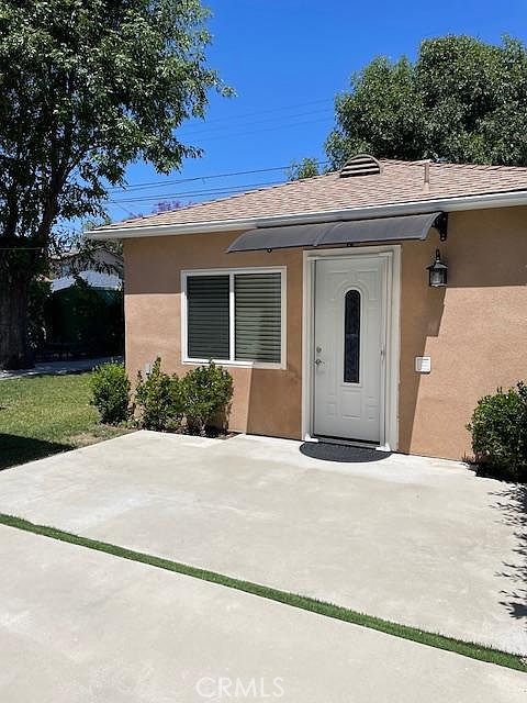 6504 Hesperia Avenue Reseda, CA 91335 - Photo 11 of 11 a front view of a house with garage and plants
