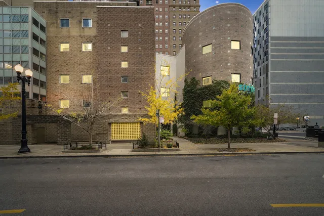 a view of a brick building next to a road