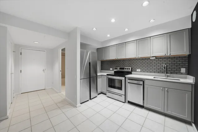 a kitchen with stainless steel appliances granite countertop a refrigerator and a sink