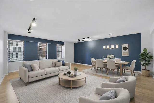 a living room with furniture and view of kitchen