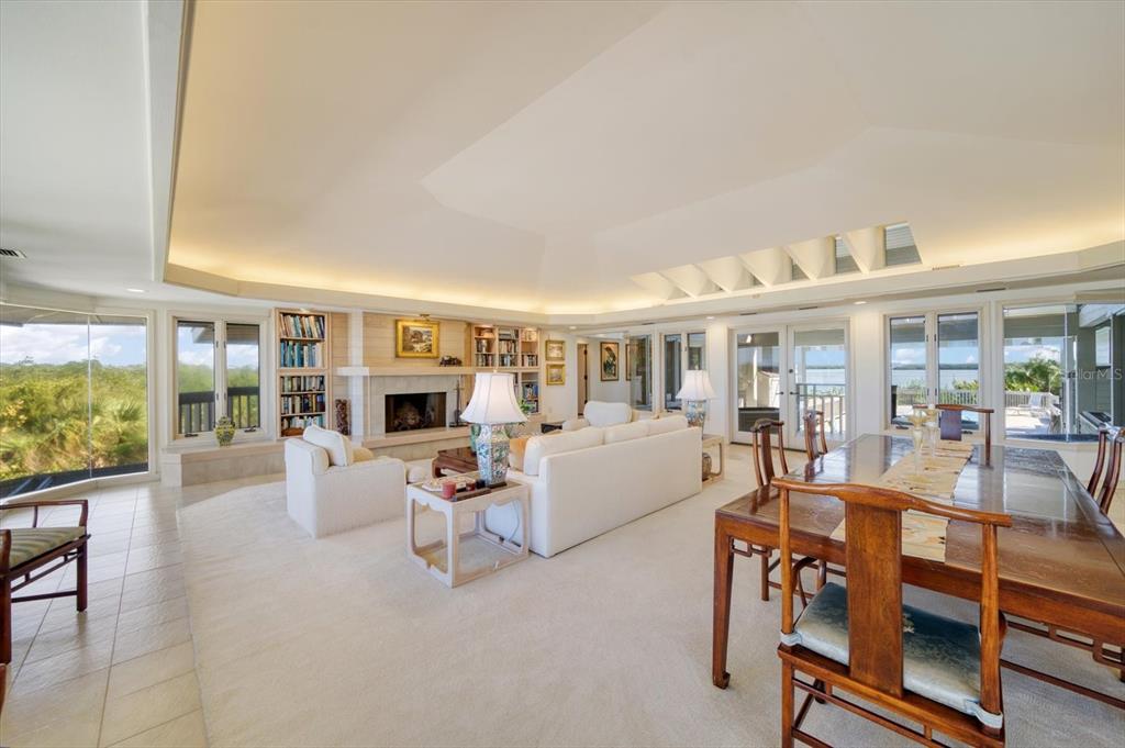 1198 Mandalay Point Road Clearwater, FL 33767 - Photo 16 of 61 a living room with furniture a fireplace and a flat screen tv
