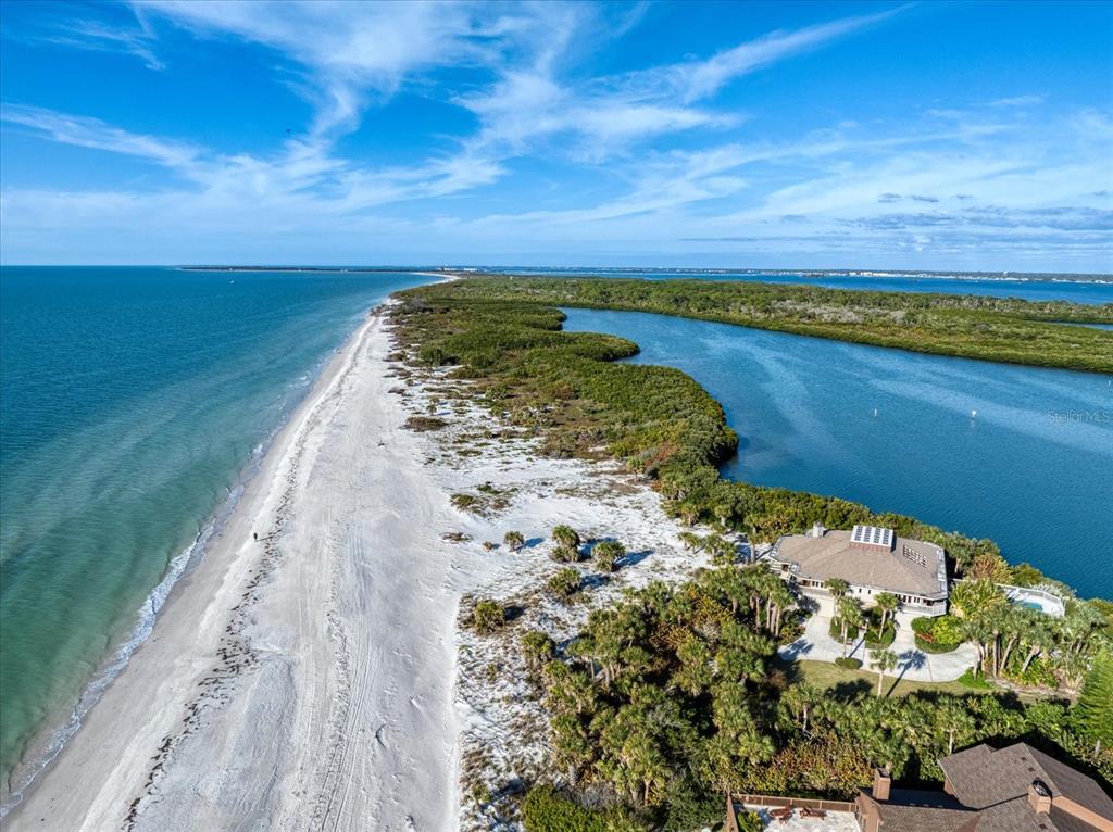 1198 Mandalay Point Road Clearwater, FL 33767 - Photo 25 of 61 a view of a lake with a garden