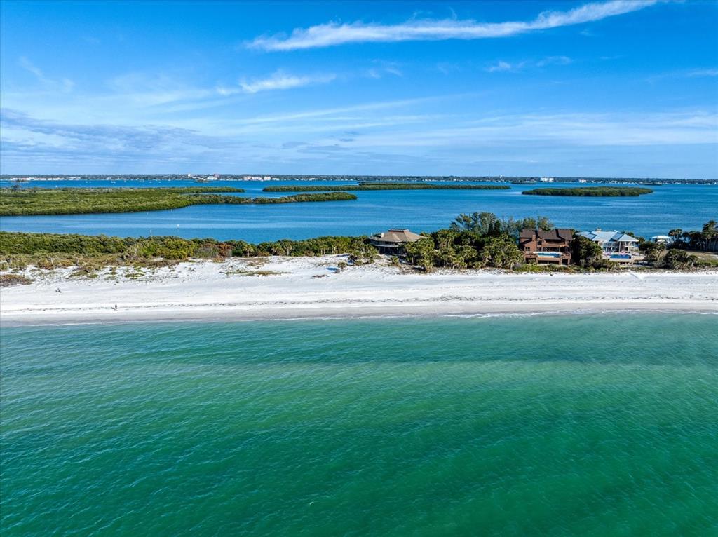 1198 Mandalay Point Road Clearwater, FL 33767 - Photo 53 of 61 a view of an ocean beach and a yard