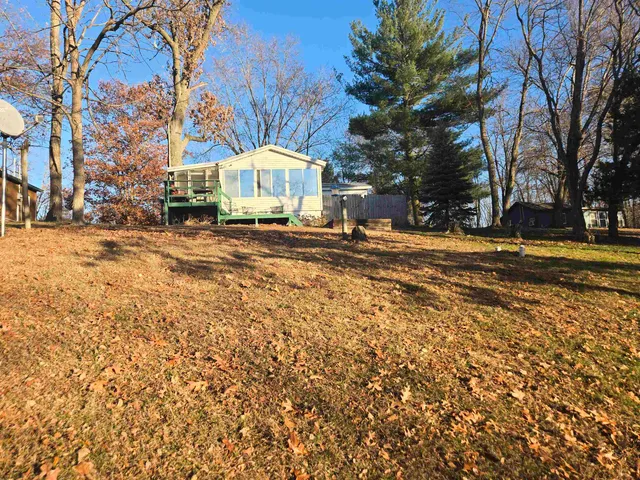 a view of a house with a yard covered in snow