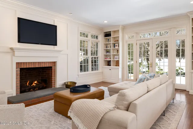a living room with furniture a fireplace and a flat screen tv