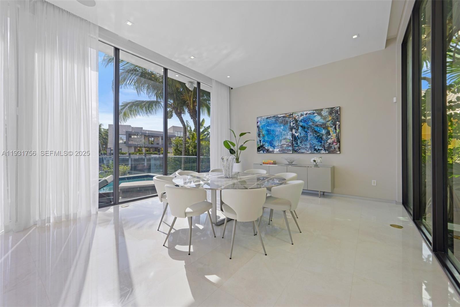3260 Northeast 165th Street North Miami Beach, FL 33160 - Photo 11 of 43 a dining room with furniture a chandelier and wooden floor