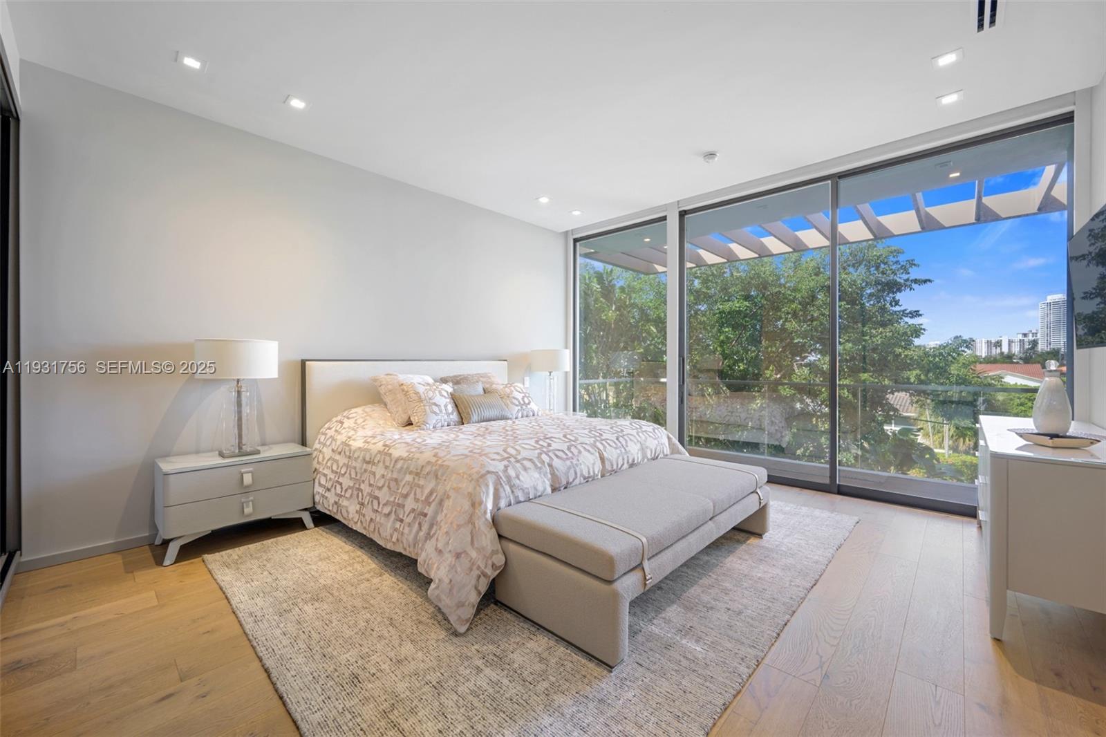 3260 Northeast 165th Street North Miami Beach, FL 33160 - Photo 29 of 43 a spacious bedroom with a large bed and a large window