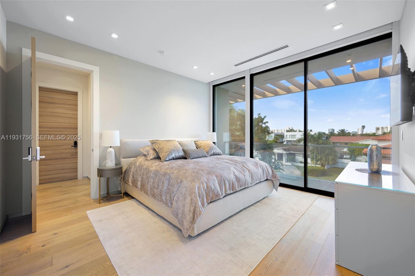3260 Northeast 165th Street North Miami Beach, FL 33160 - Photo 31 of 43 a spacious bedroom with a large bed and a large window