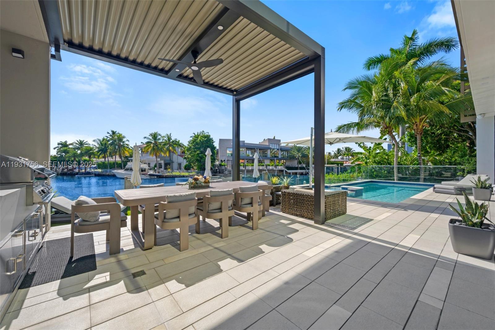 3260 Northeast 165th Street North Miami Beach, FL 33160 - Photo 37 of 43 a view of a patio with couches table and chairs and potted plants
