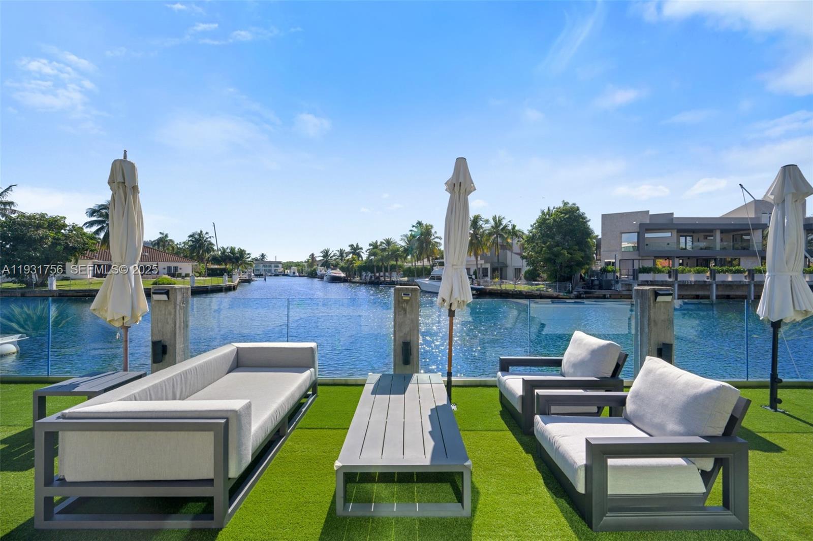 3260 Northeast 165th Street North Miami Beach, FL 33160 - Photo 41 of 43 a view of a patio with couches chairs and a table