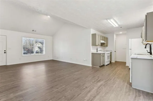 a view of kitchen with wooden floor and electronic appliances