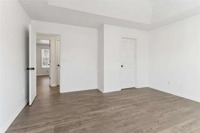 a view of an empty room with wooden floor