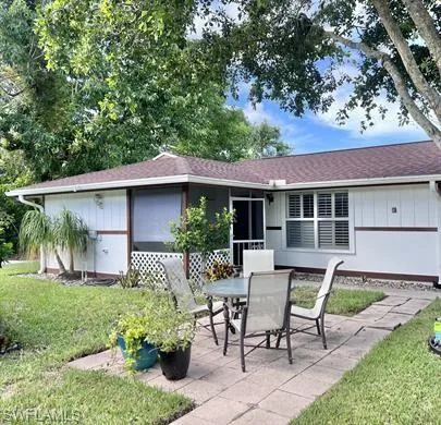 a view of a house with backyard sitting area and garden