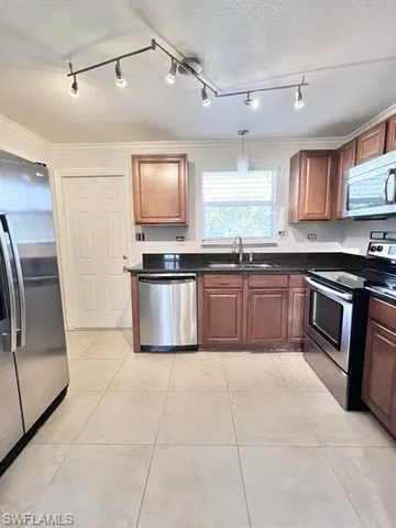 a large kitchen with cabinets and stainless steel appliances