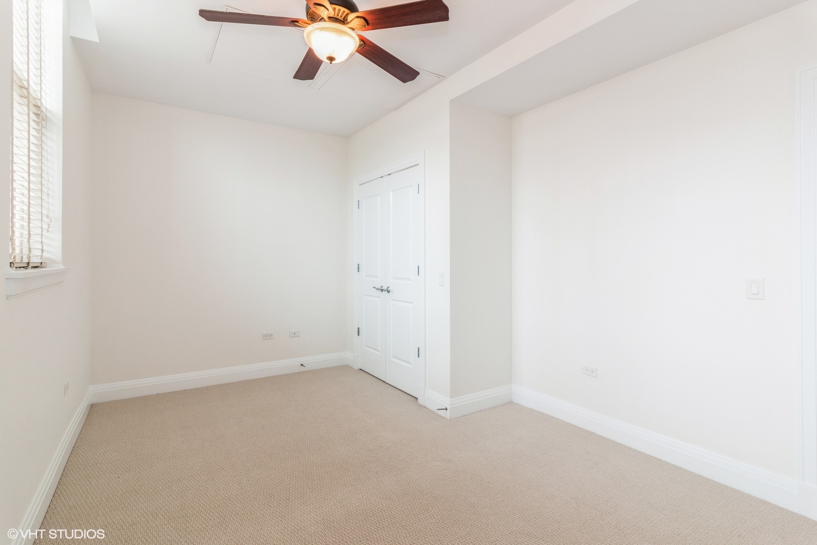 1041 Ridge Road, Unit 517 Wilmette, IL 60091 - Photo 7 of 12 an empty room with a window and a fan