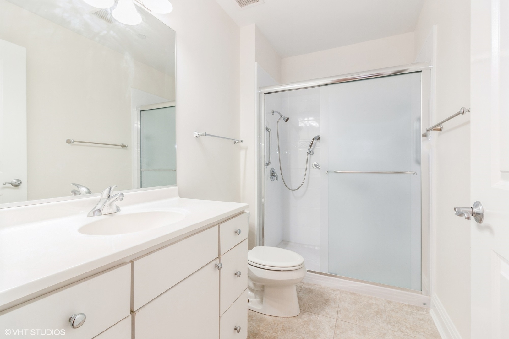 1041 Ridge Road, Unit 517 Wilmette, IL 60091 - Photo 10 of 12 a bathroom with a sink a toilet and shower