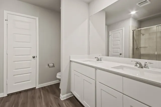 a bathroom with a double vanity sink and mirror