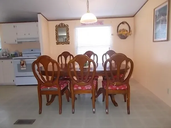 a dining room with furniture and window