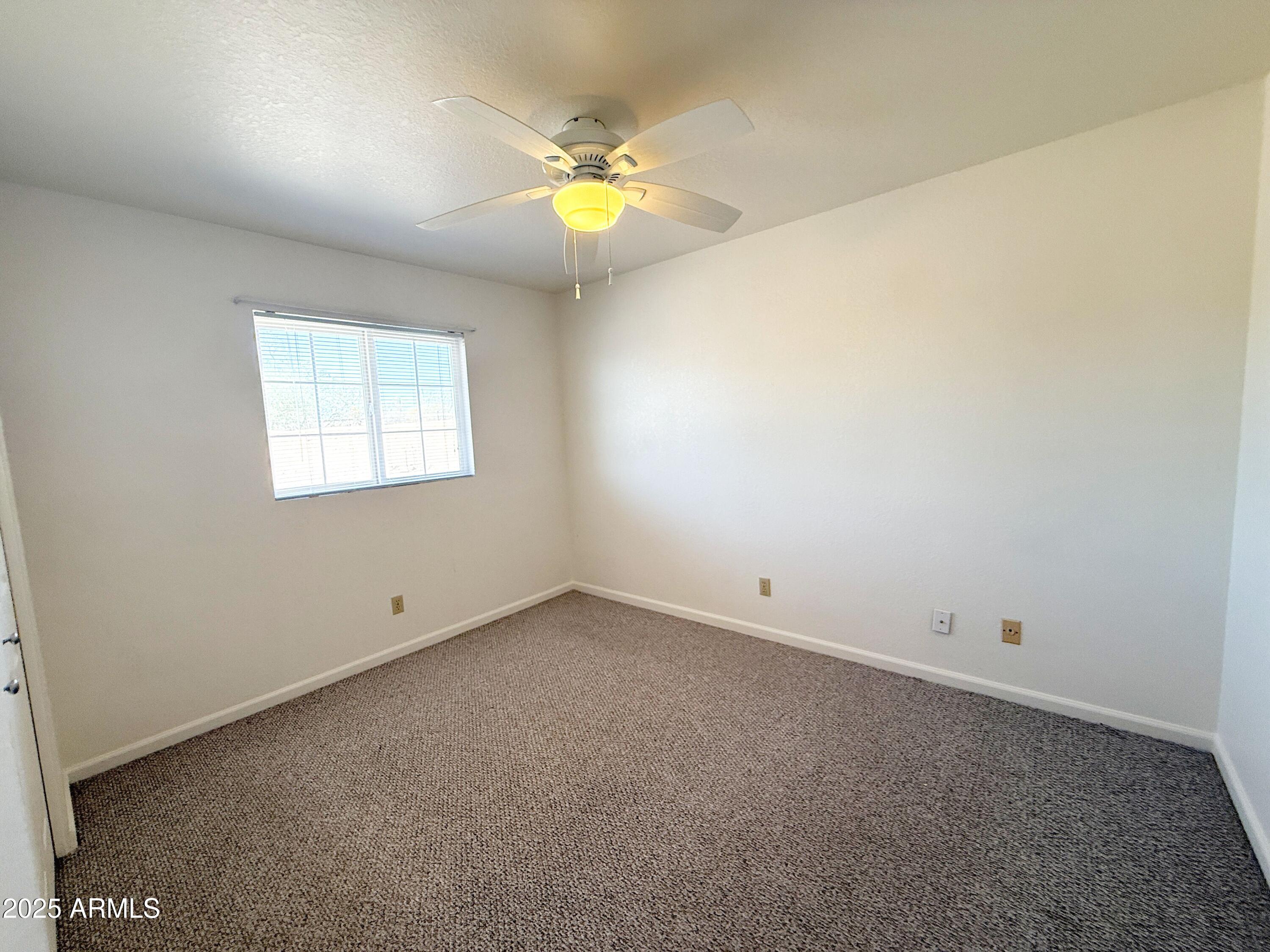 867 North Arroya Road Apache Junction, AZ 85119 - Photo 12 of 19 an empty room with a window