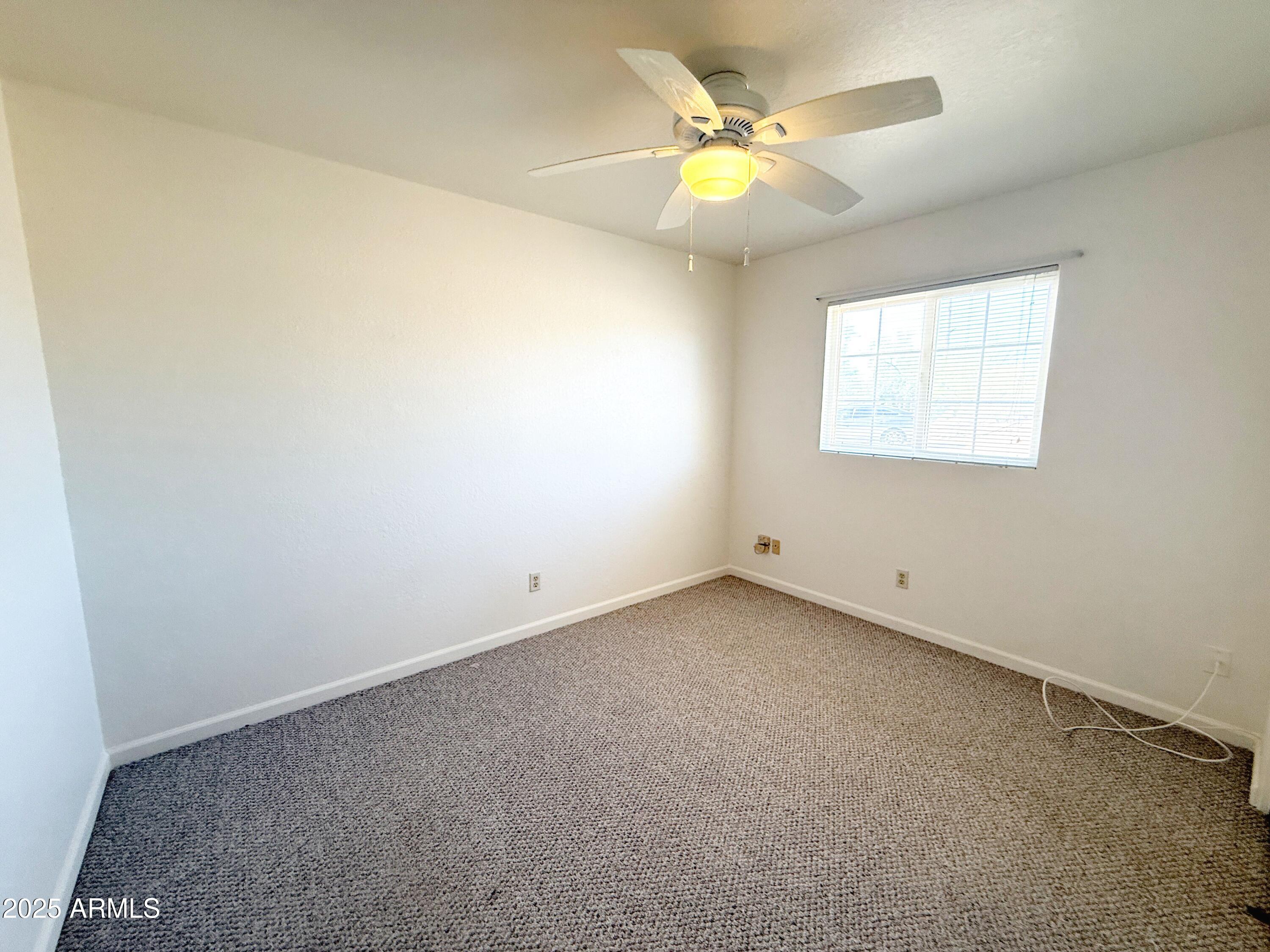 867 North Arroya Road Apache Junction, AZ 85119 - Photo 14 of 19 an empty room with a window
