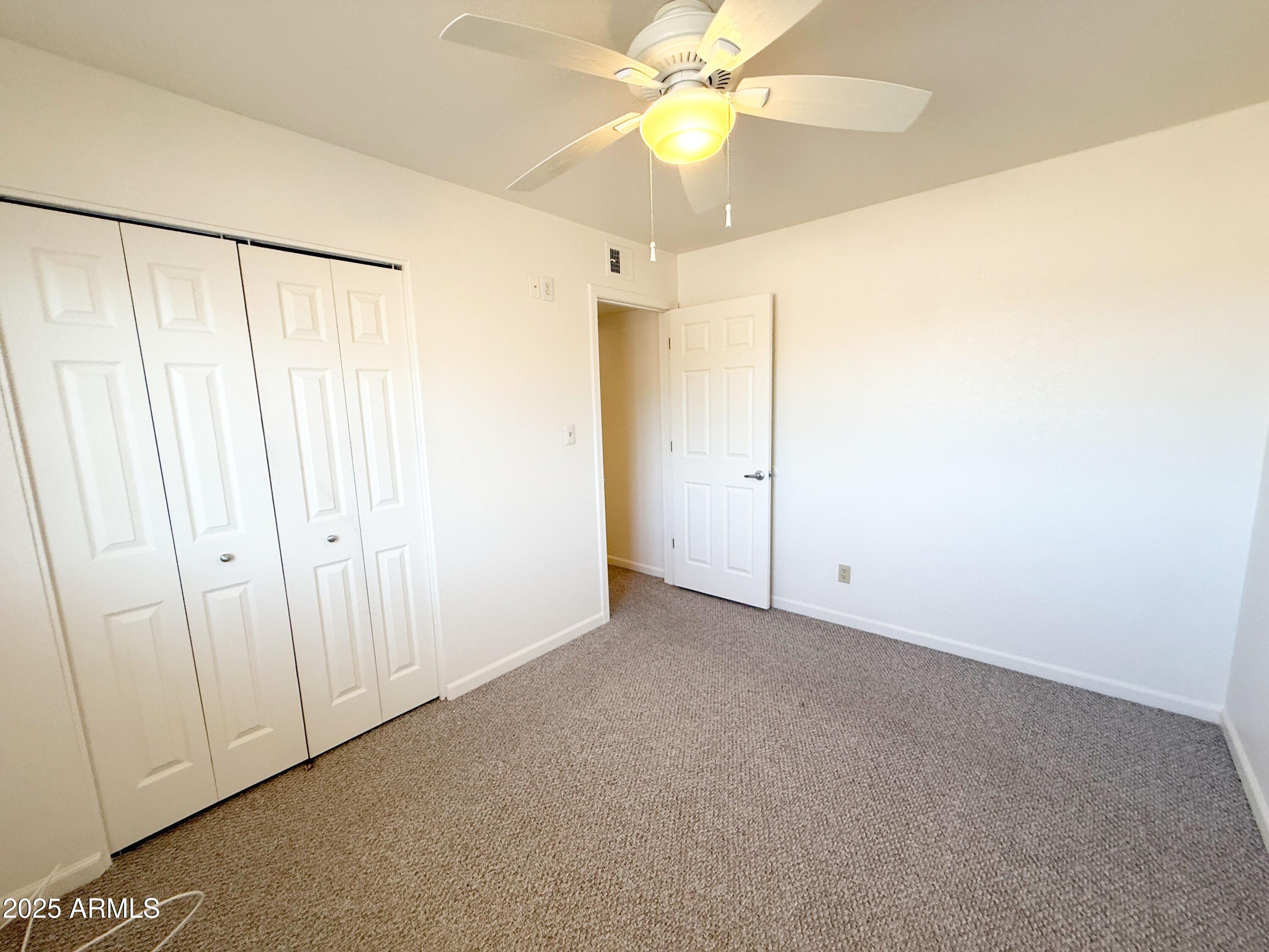 867 North Arroya Road Apache Junction, AZ 85119 - Photo 15 of 19 an empty room with a fan & a window