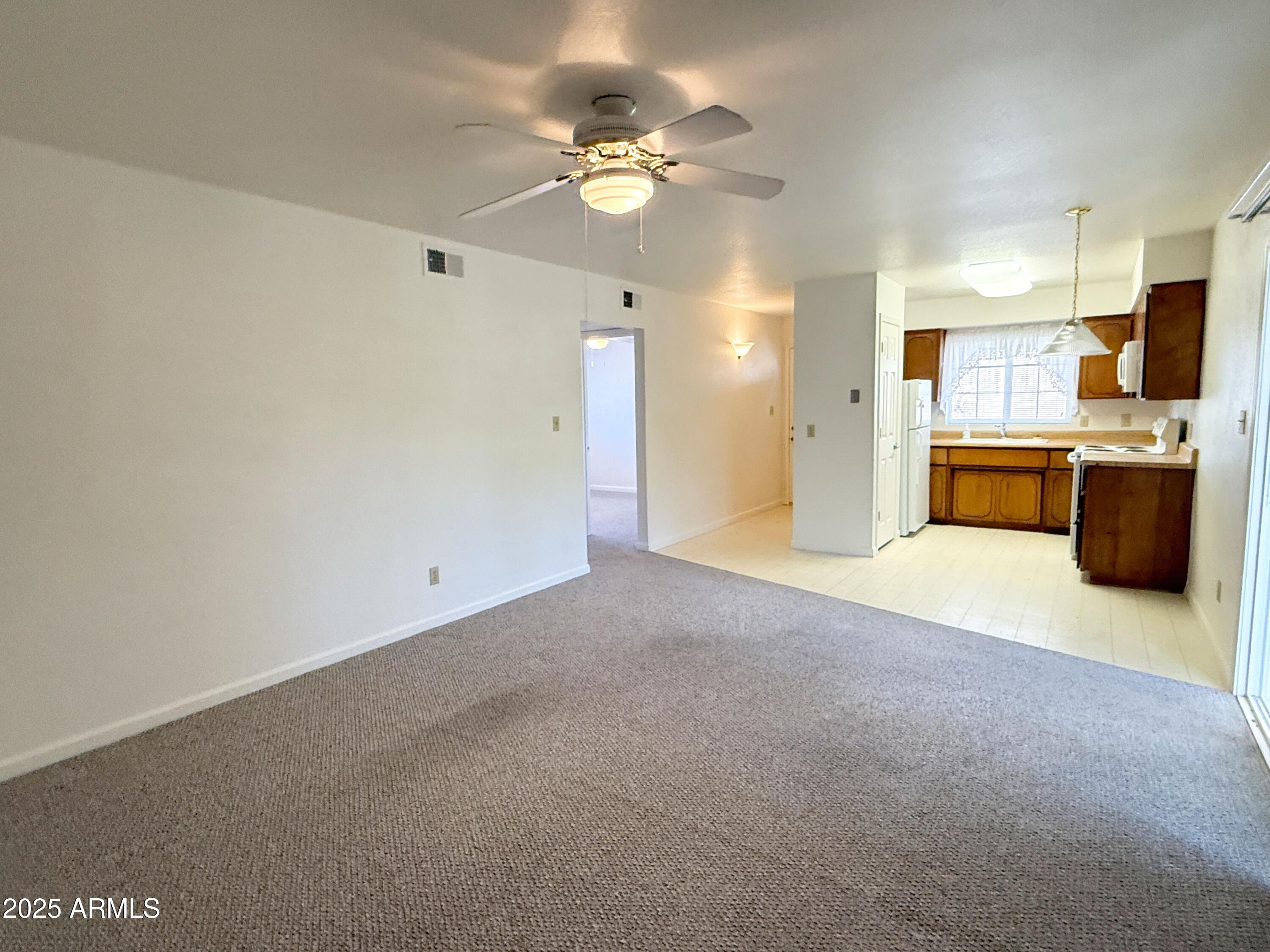 867 North Arroya Road Apache Junction, AZ 85119 - Photo 5 of 19 a view of a kitchen with a sink and a refrigerator