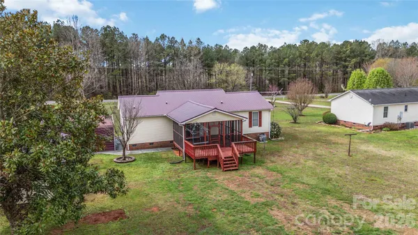 an aerial view of a house with garden space and street view
