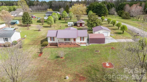 an aerial view of a house with yard swimming pool and outdoor seating