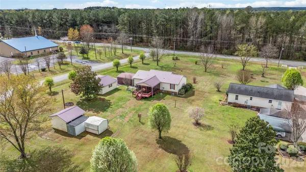 an aerial view of residential houses with outdoor space and parking