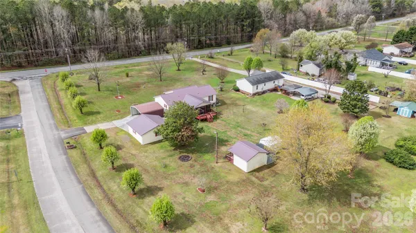 an aerial view of a house with a yard basket ball court