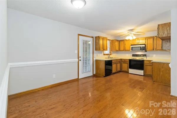a view of a kitchen with a sink stove and cabinets