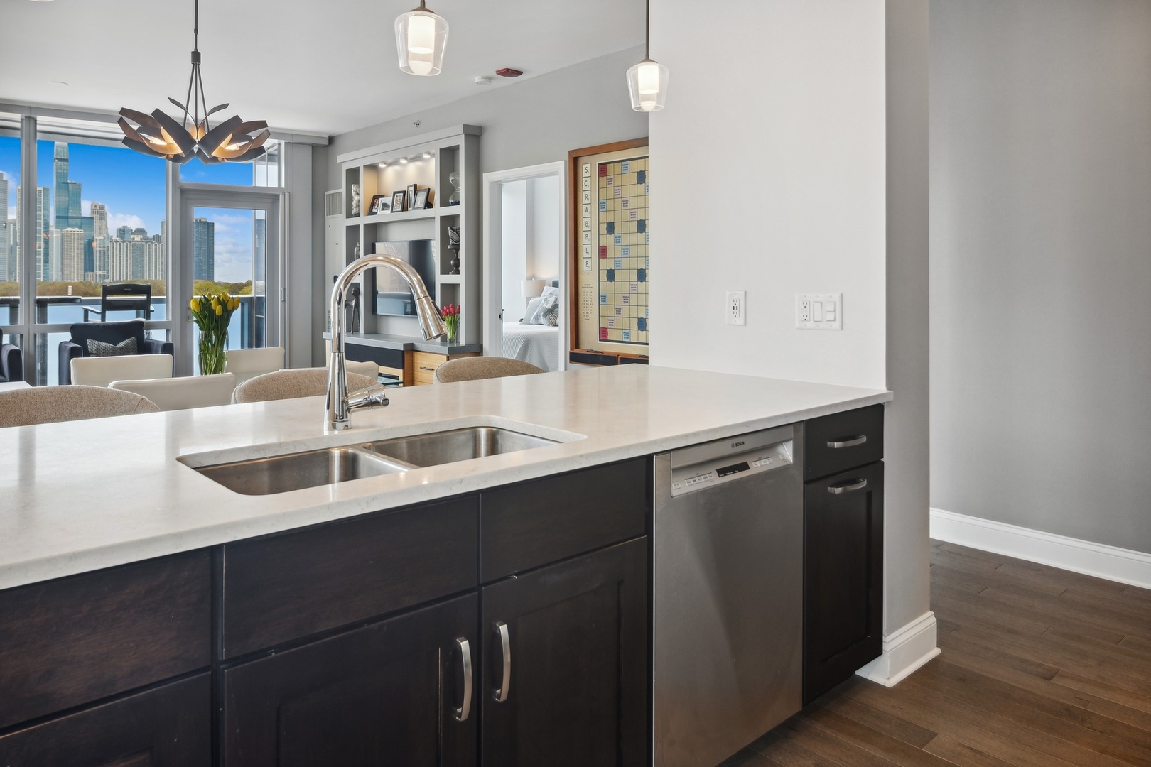 1211 South Prairie Avenue, Unit 606 Chicago, IL 60605 - Photo 12 of 44 a kitchen with a sink dishwasher and a stove with wooden floor