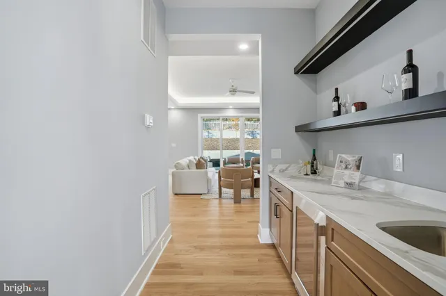 a kitchen with stainless steel appliances granite countertop a kitchen island hardwood floor sink stove dining table and chairs