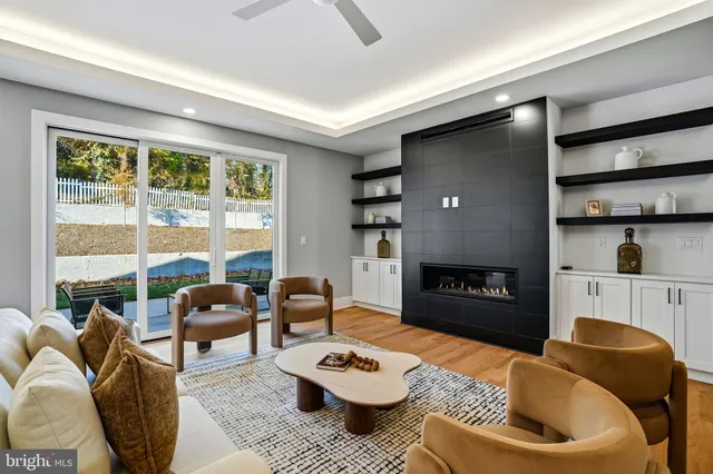 a dining room with furniture wooden floor a potted plant and a chandelier