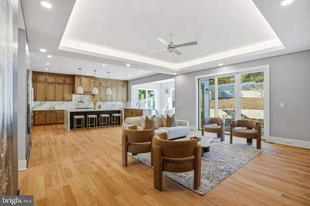 a dining room with furniture wooden floor a potted plant and a chandelier