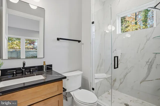 a bathroom with a sink toilet vanity and tub