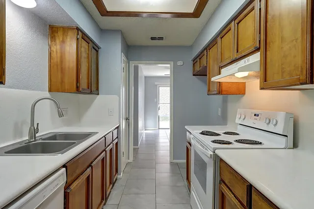 a kitchen that has a sink and a stove