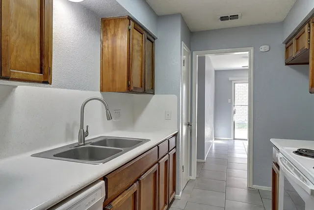 a kitchen with a sink and a refrigerator