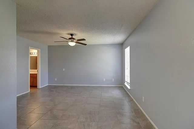 a view of a livingroom with a ceiling fan and window