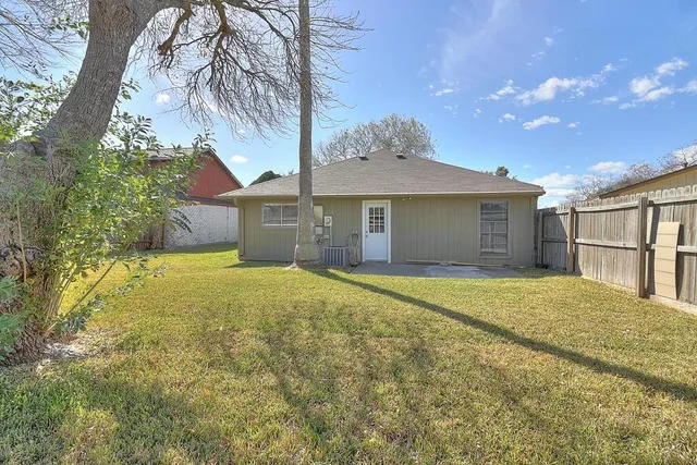 a front view of a house with a garden and yard