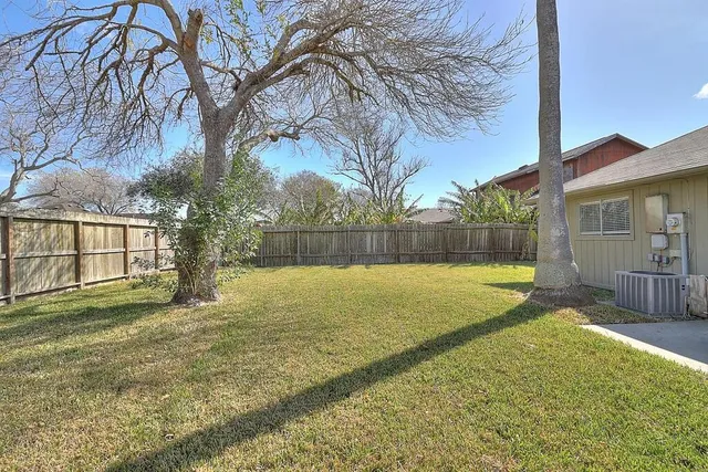 a view of backyard with swimming pool and seating space