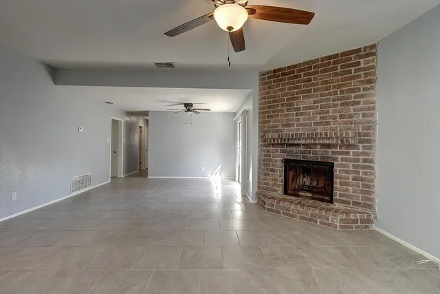 a view of an empty room with a fireplace