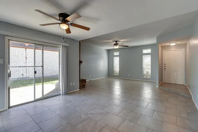 a view of a livingroom with a ceiling fan and window