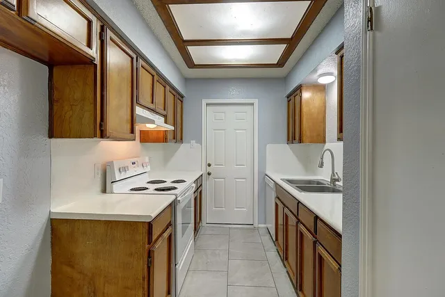 a kitchen that has a sink and a stove