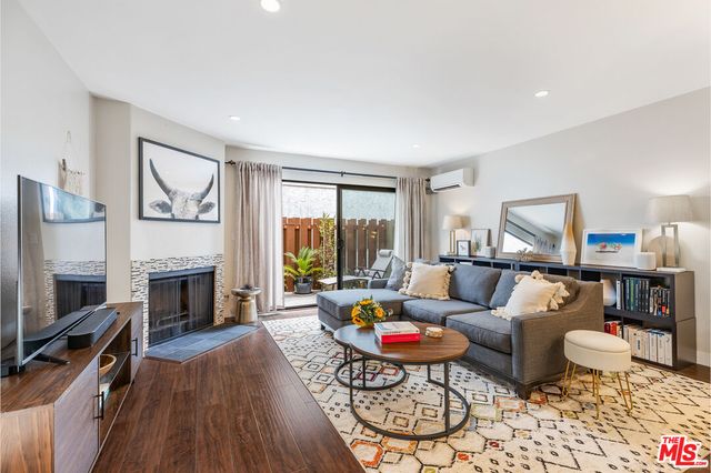 a view of a workspace with furniture and wooden floor