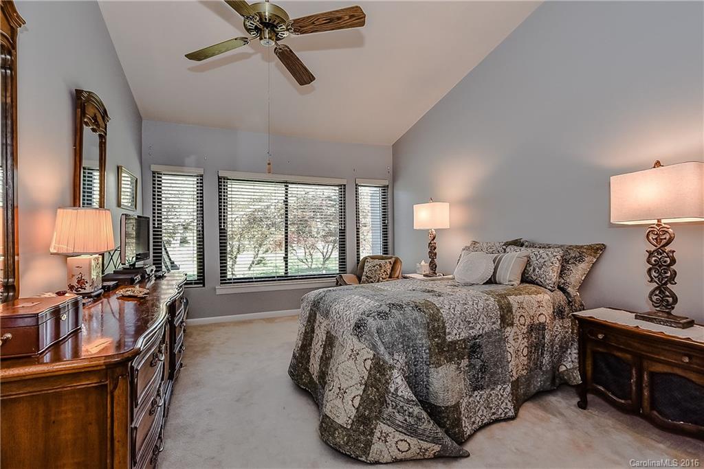 105 Ridgeport Road, Unit 105 Clover, SC 29710 - Photo 14 of 24 a spacious bedroom with a bed a couch and dresser next to a window