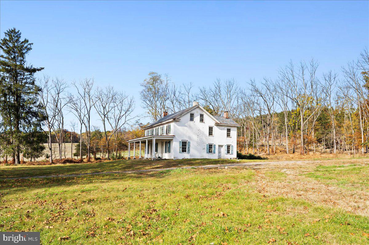 6859 Phillips Mill Road New Hope, PA 18938 - Photo 5 of 18 a front view of a building with a yard