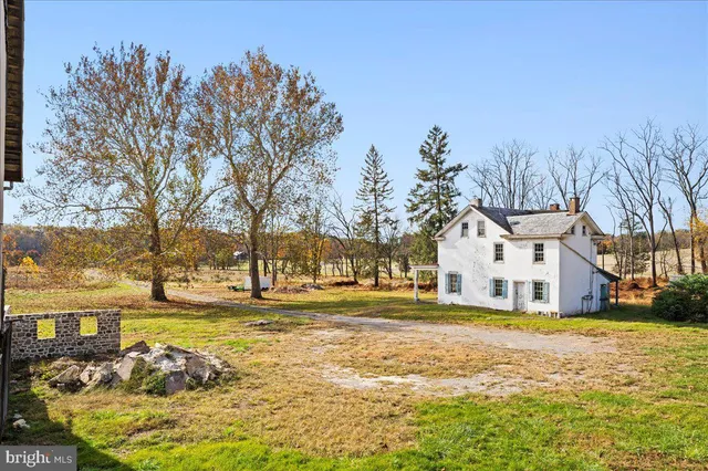 a view of a white house with a yard
