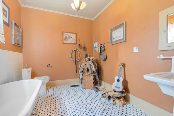 a bathroom with a sink a toilet and a mirror