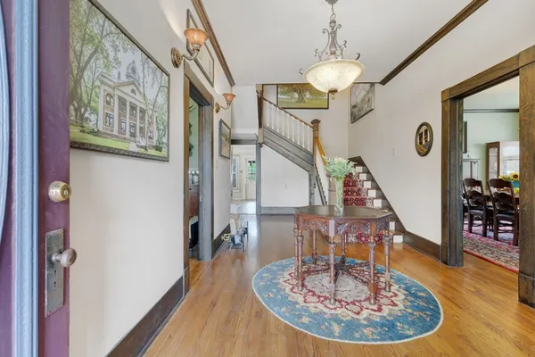 a view of entryway and hall with wooden floor